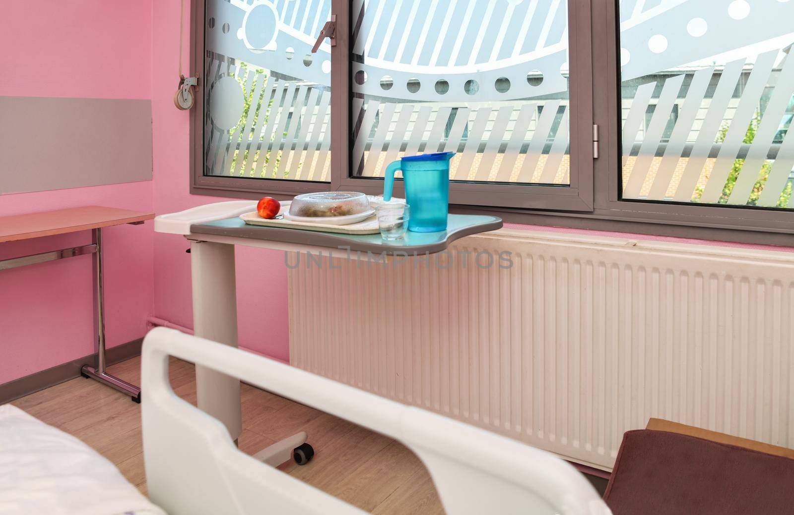 Food on a mobile tray in a modern hospital ward