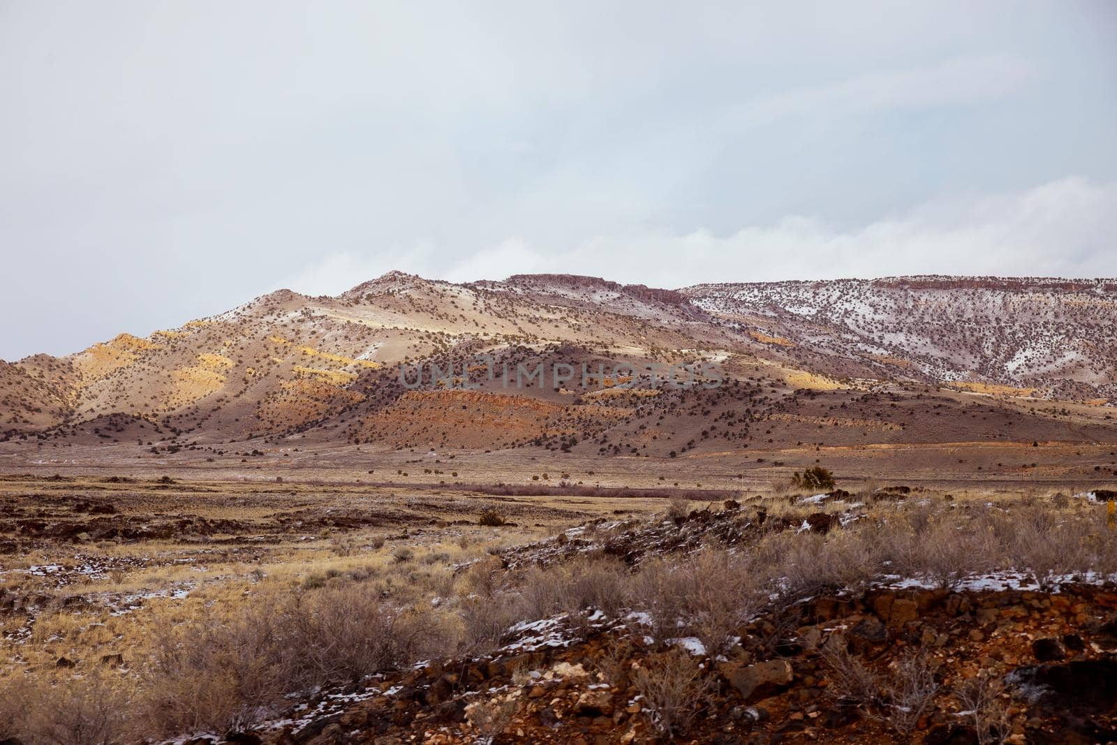 Mountain with snow covered of desert rocks in winter New Mexico by ungvar