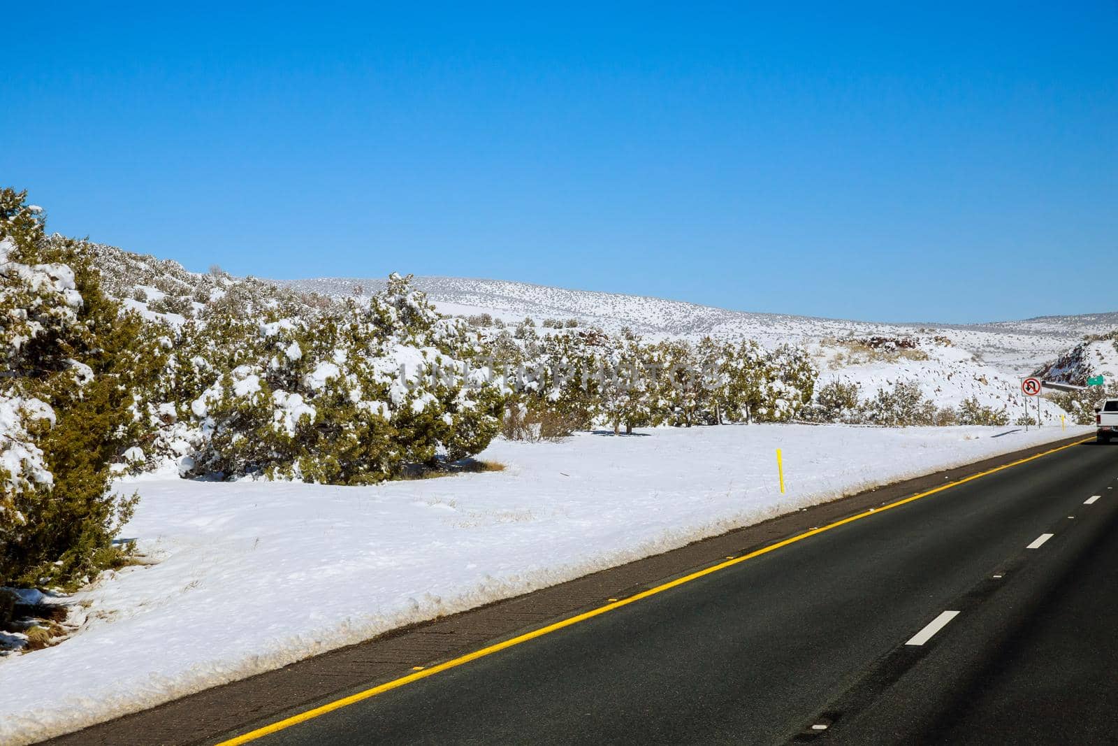The scenery of a valley after a snowstorm, trees forest snowy road of Interstate 17 in Arizona USA