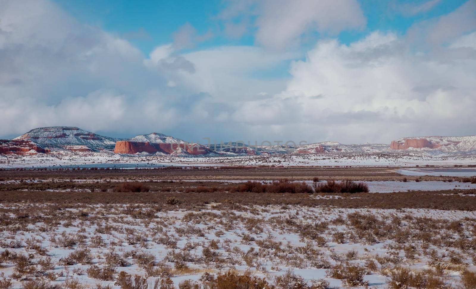 I-40 highway snow covered valley on overcast day in New Mexico by ungvar