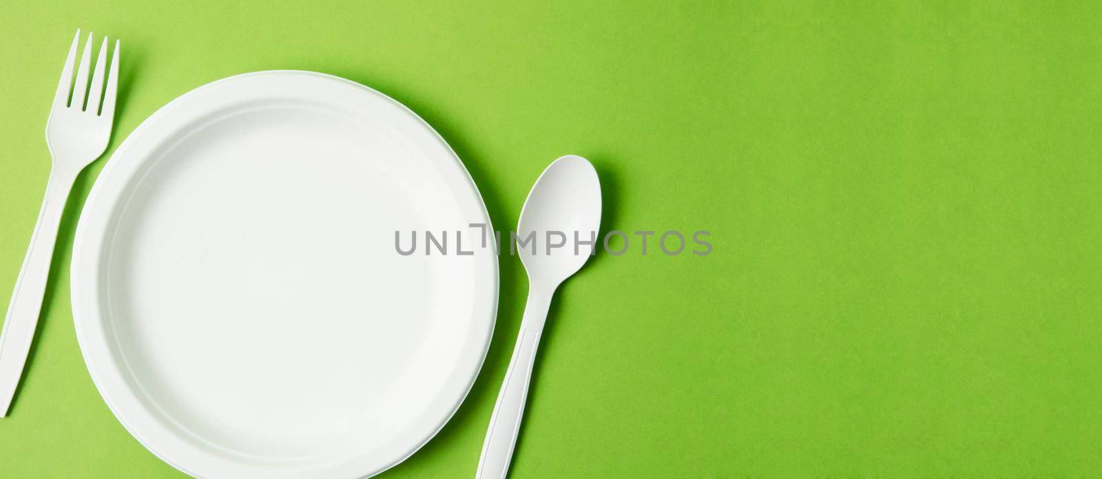 Eco friendly biodegradable paper disposable for packaging food and paper glass on green background. by Gamjai