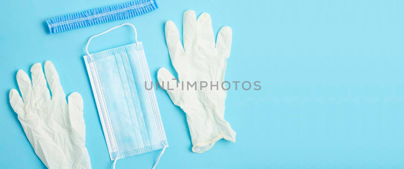 Medical gear protecting against transmittable diseases, on blue background by Gamjai