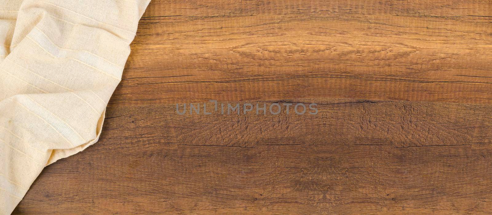 Tablecloth textile with empty space on wooden background.