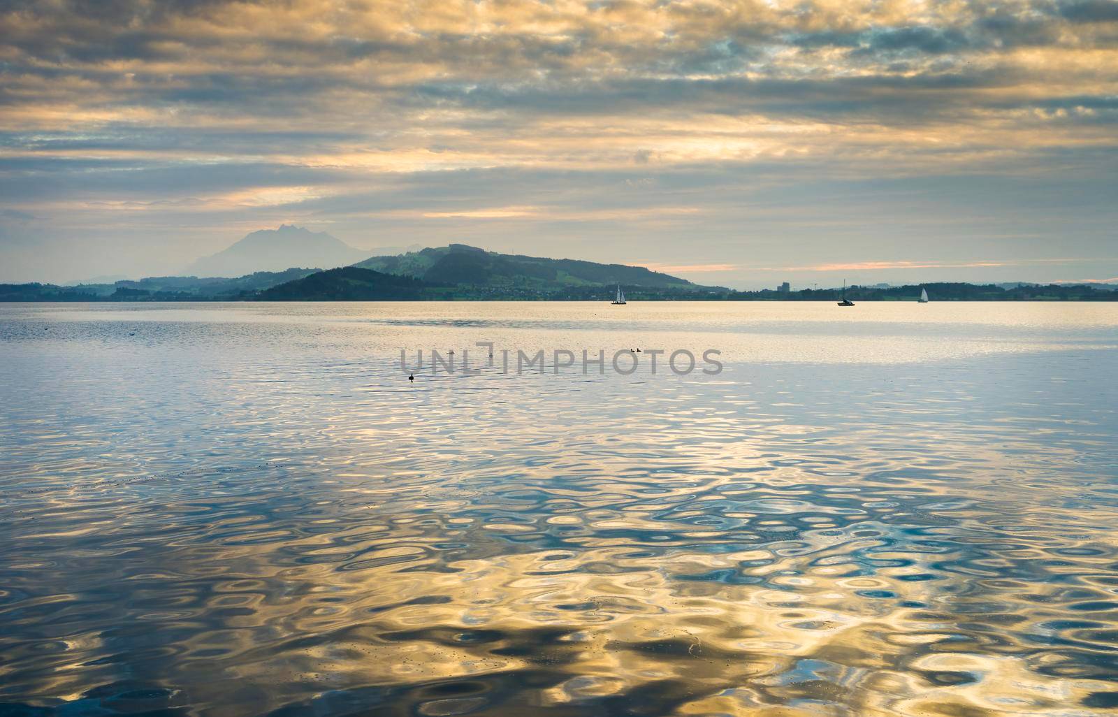 View of Lake Zugersee in the Swiss town of Zug at sunset. by csbphoto