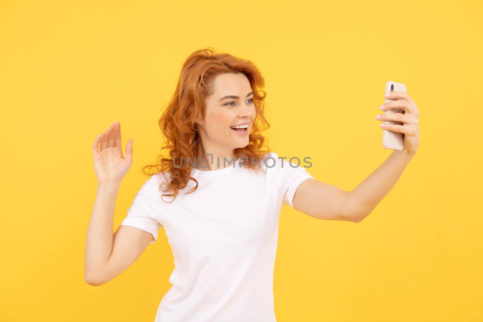 Image of excited happy young woman isolated overyellow background make selfie by camera. by RedFoxStudio