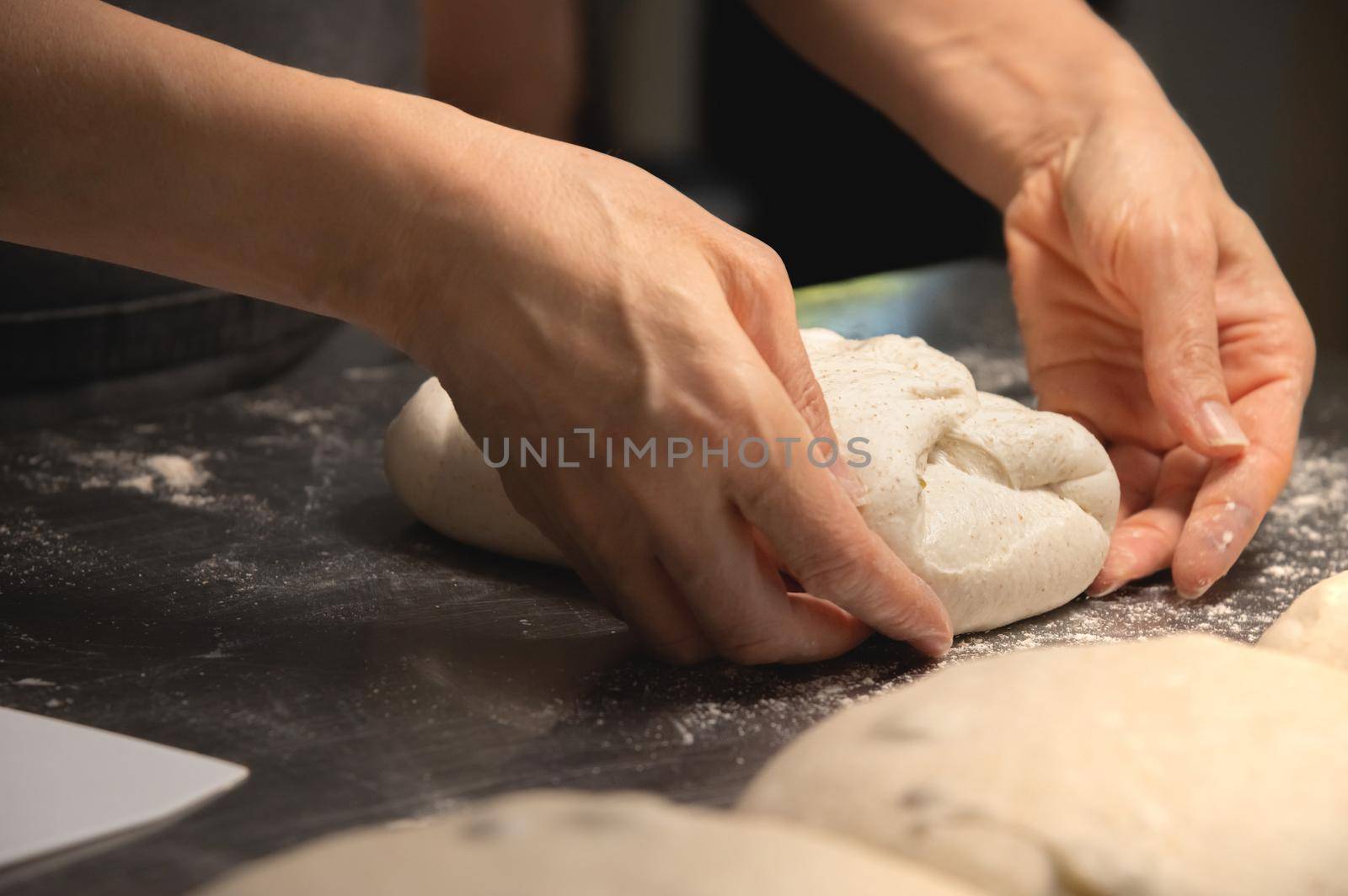 Close-up baker making bread, female hands, kneading dough, cooking by yanik88
