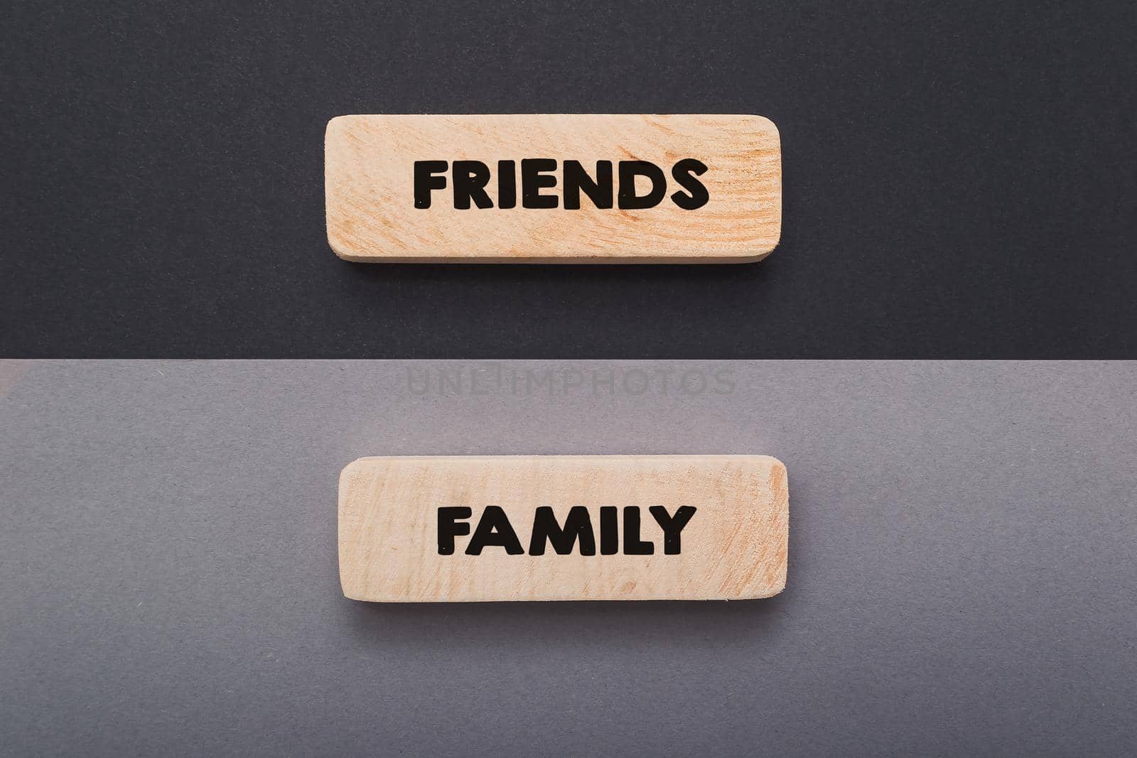 Hand writing word friend and family text on wooden board. Life balance chart