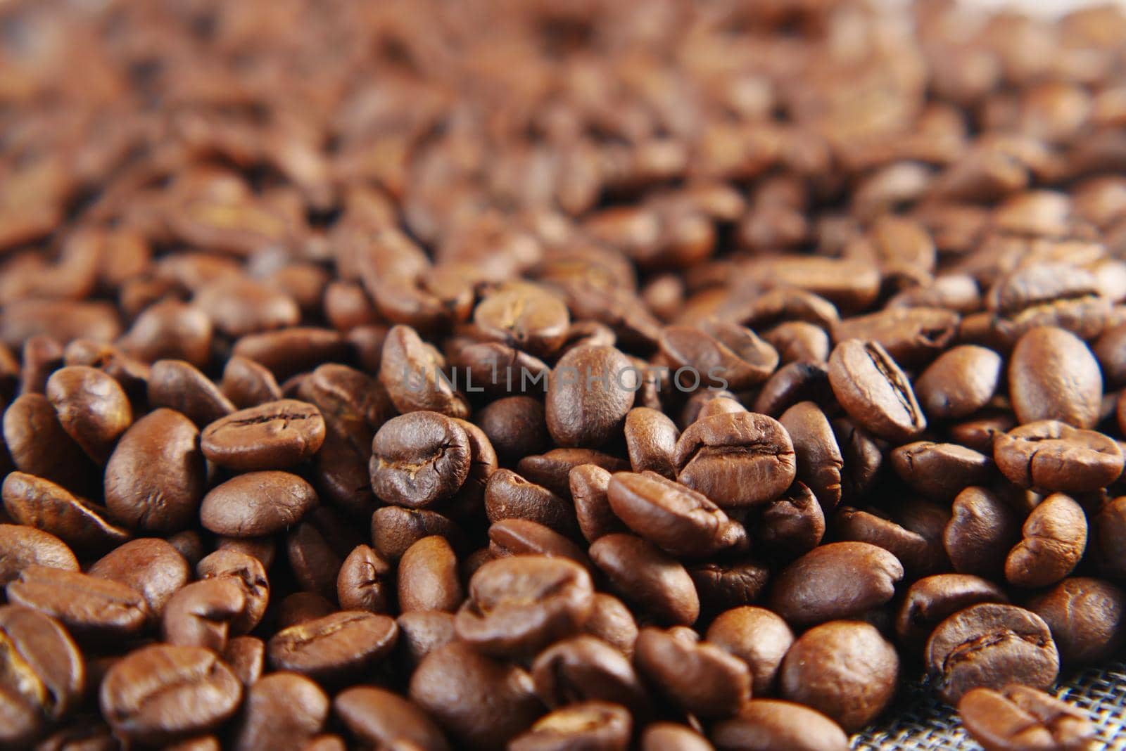 top view of fresh coffee beans on black background with copy space