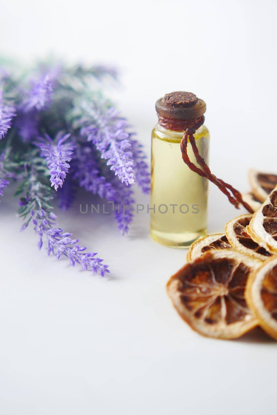 Essential lavender oil and flowers on table with copy space .