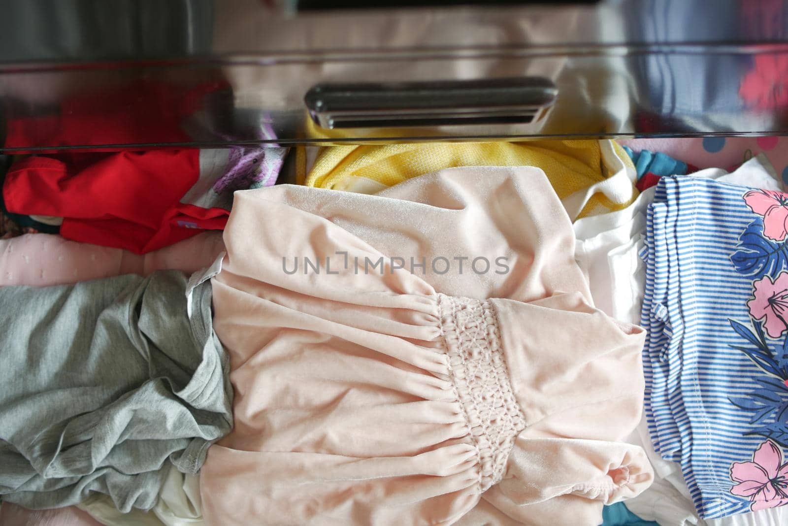 cloths in a open drawer wooden .
