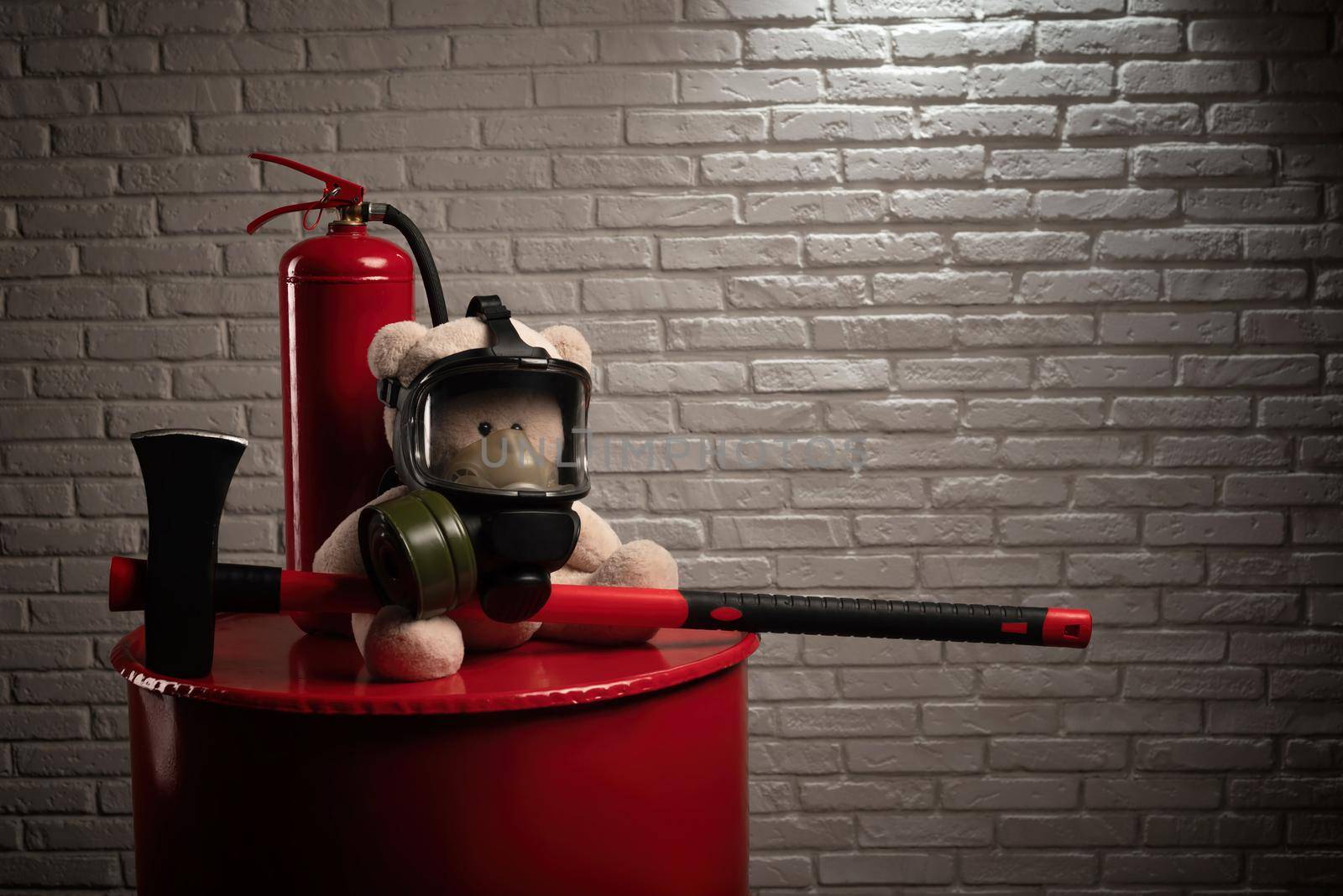 mascot of the fire brigade is a teddy bear in a gas mask with a fire extinguisher and a red axe in smoke