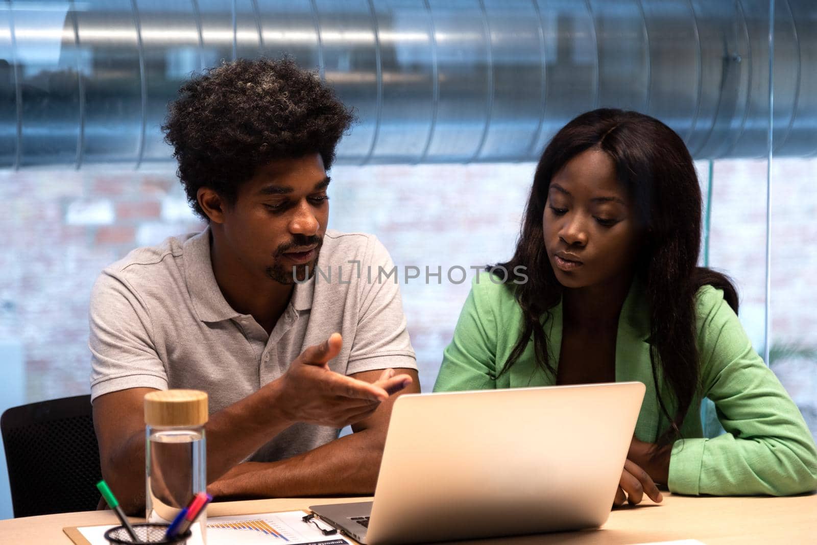 African American coworkers work together at the office using laptop. Business and technology concept.