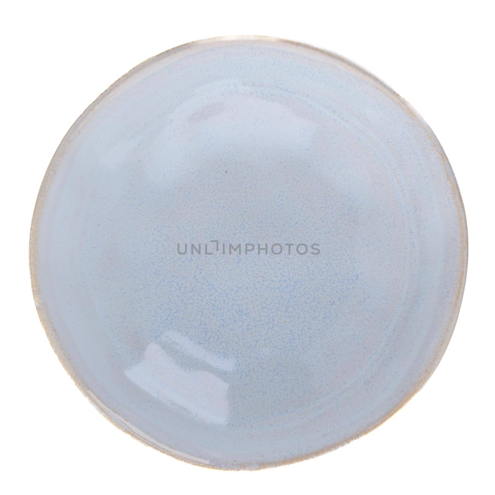 Blue ceramic bowl on white reflective background