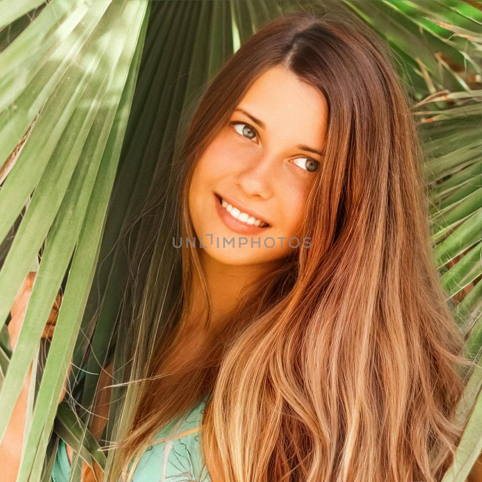 Hairstyle, beauty and summer portrait. Beautiful young woman with long dark hair, happy brunette smiling, tropical palm tree leaves on background.