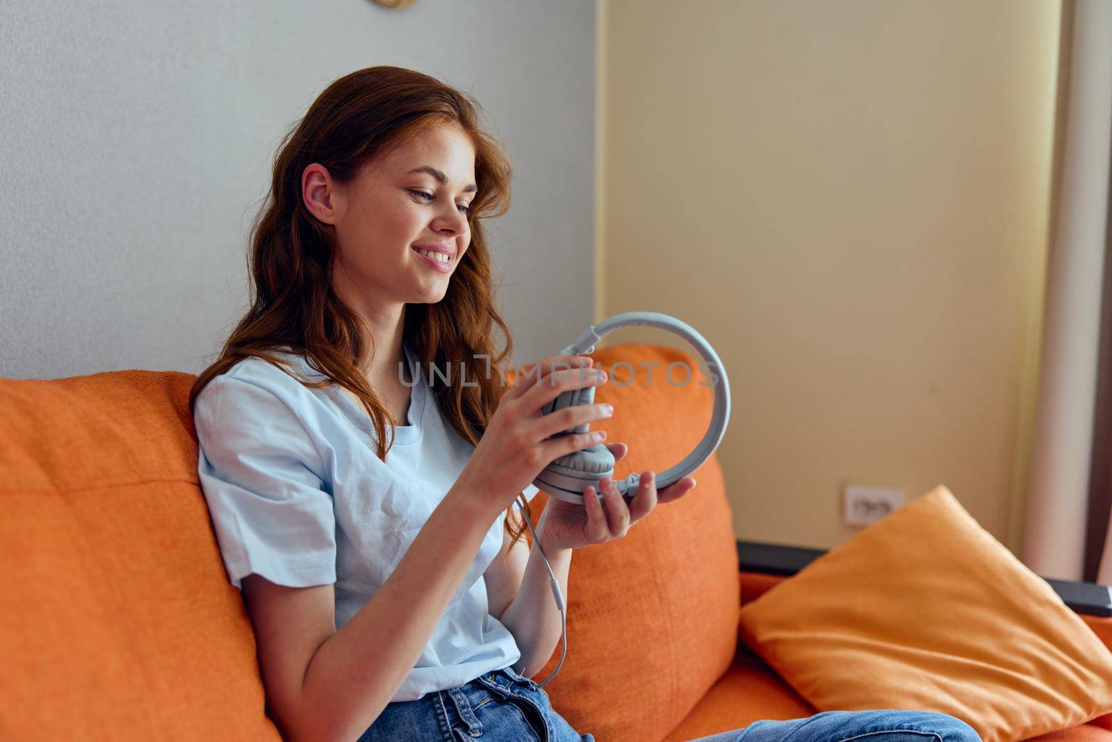 woman headphone at home on the couch entertainment Lifestyle. High quality photo