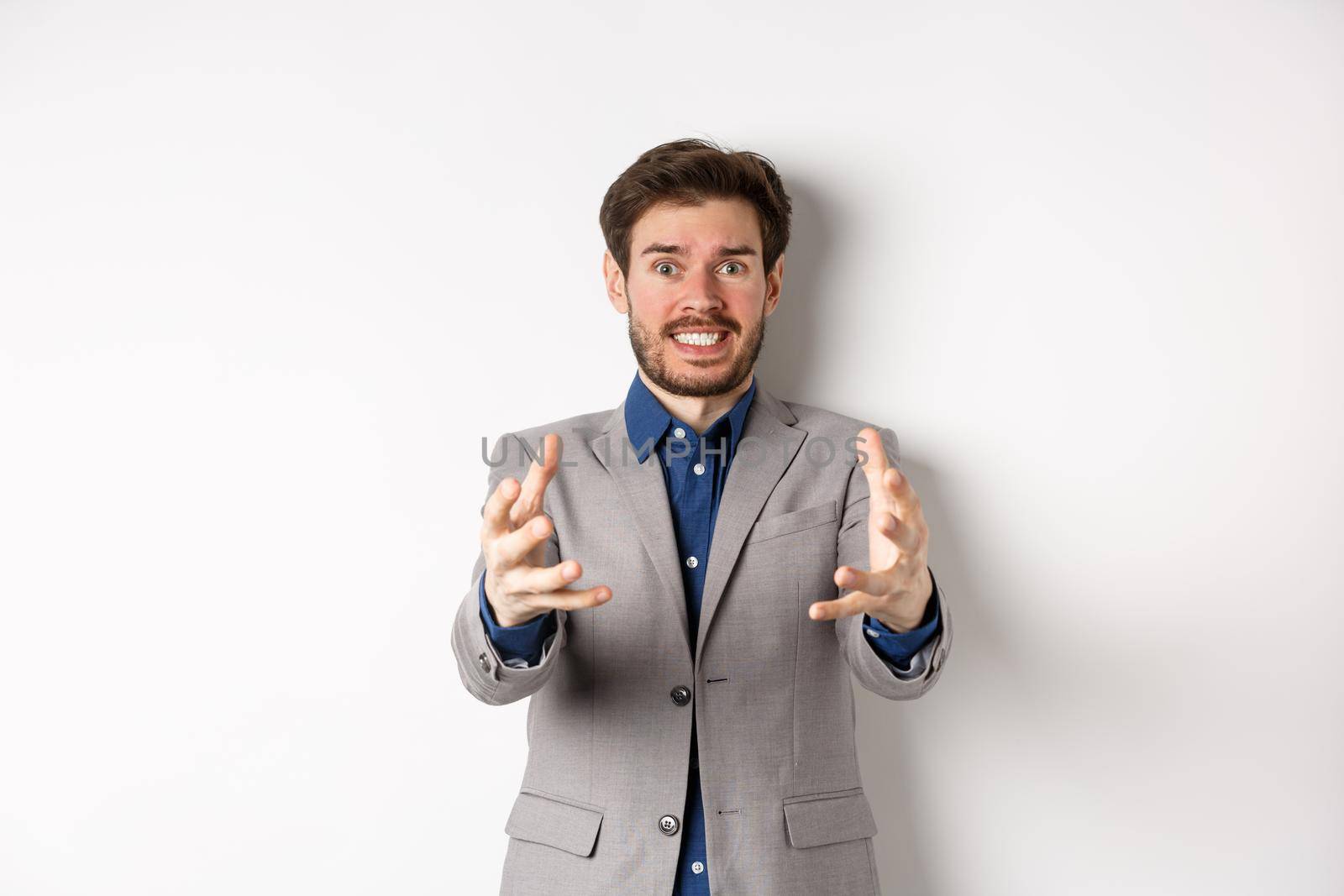 Distressed businessman stretch out hands to strangle annoying person, standing annoyed and frustrated against white background, wearing suit by Benzoix