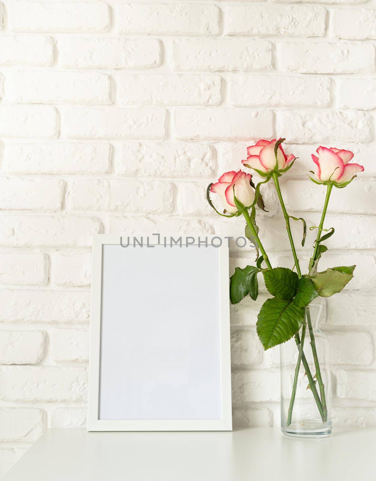 Poster mock up with frame and pink roses by Desperada