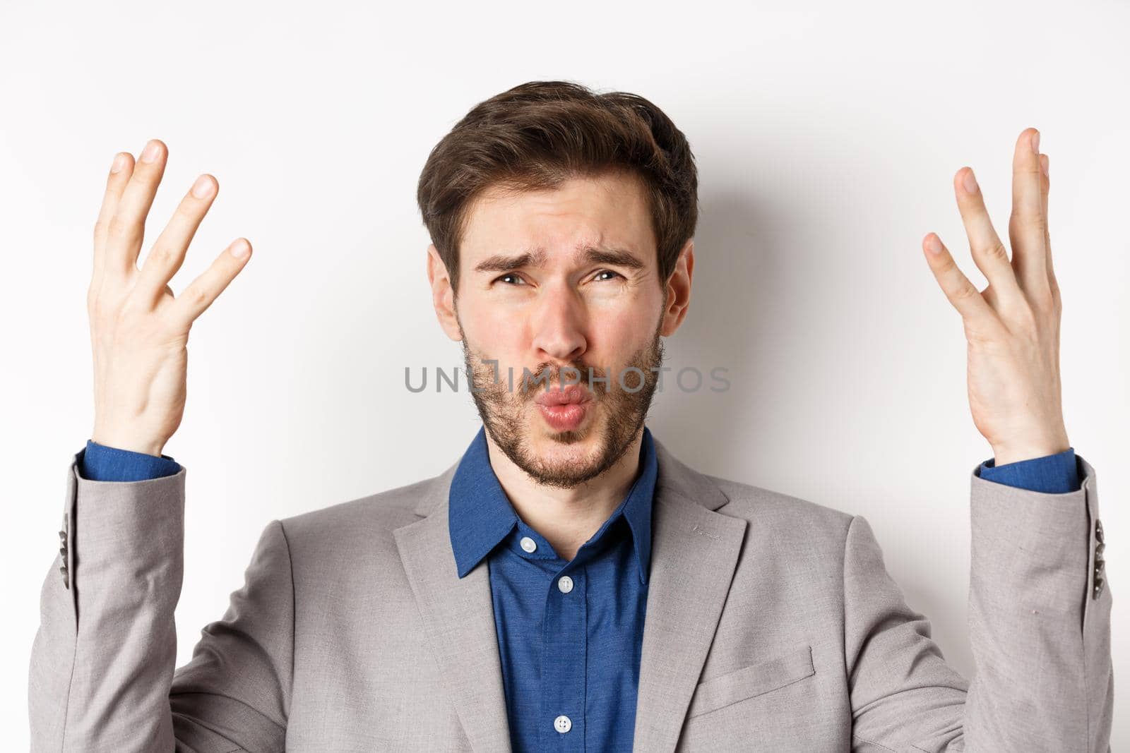 Frustrated businessman shaking hands and asking wtf what happened, looking disappointed and shocked at camera, scolding employee, white background by Benzoix