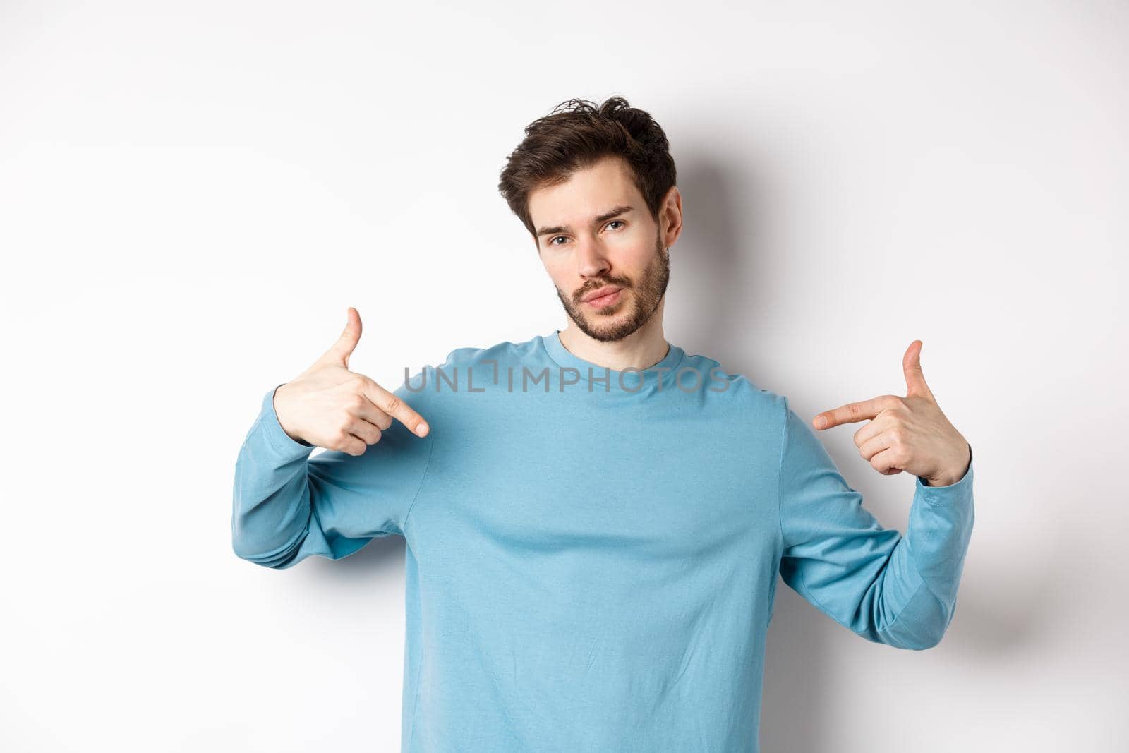 Young man with beard feeling confident, pointing at himself and making smug face, standing on white background cool and sassy by Benzoix