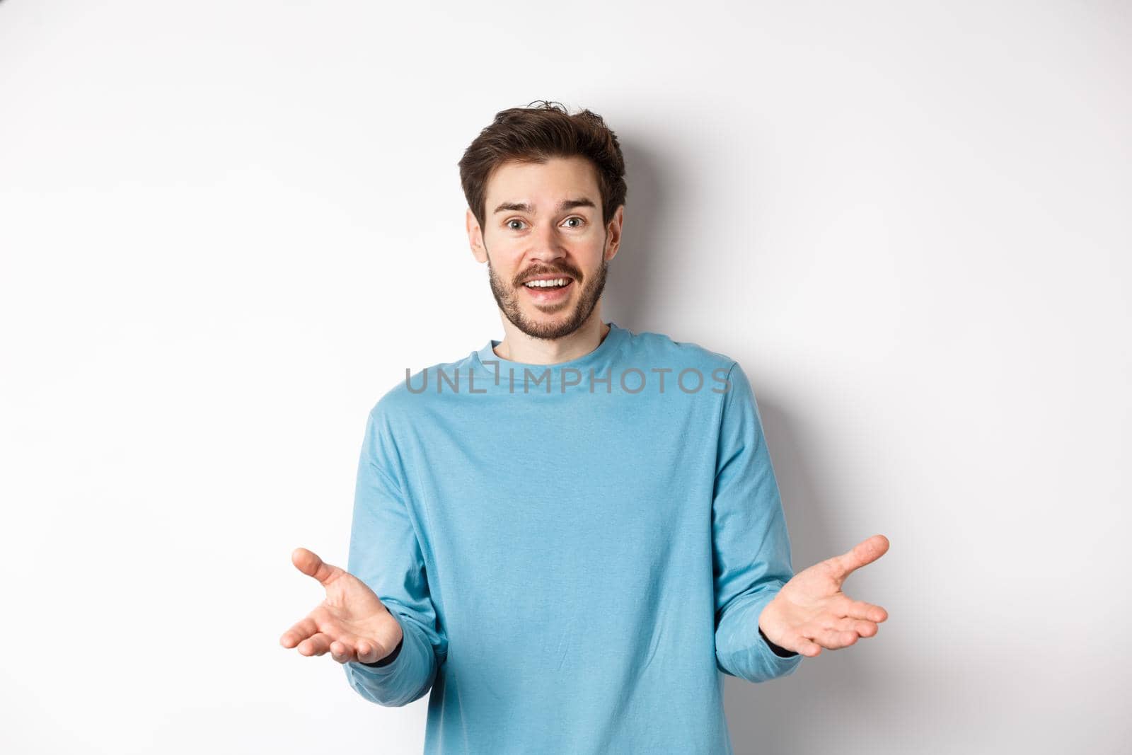 Handsome young man feeling happy for you, pointing hands at camera and praising good work, congratulations gesture, standing over white background by Benzoix