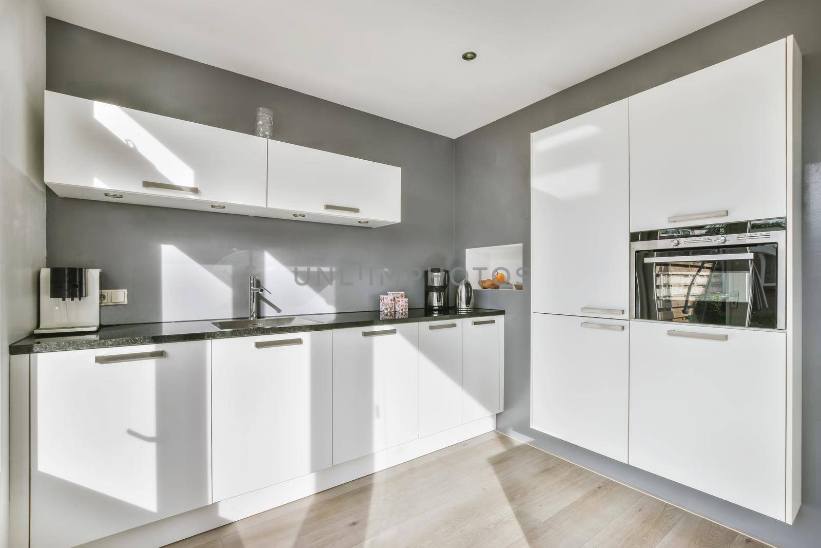 White large luxury modern kitchen with dark chairs