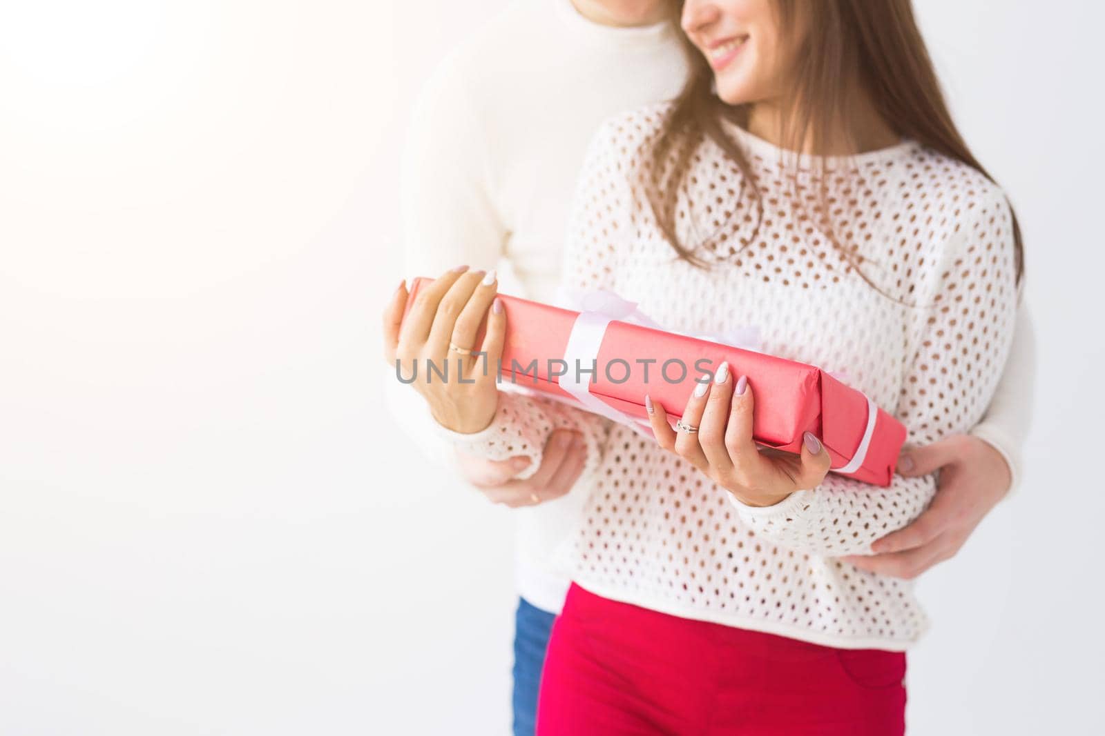 People, christmas, birthday, holidays and valentine's day concept - happy young man and woman with gift boxes on white background with copy space.