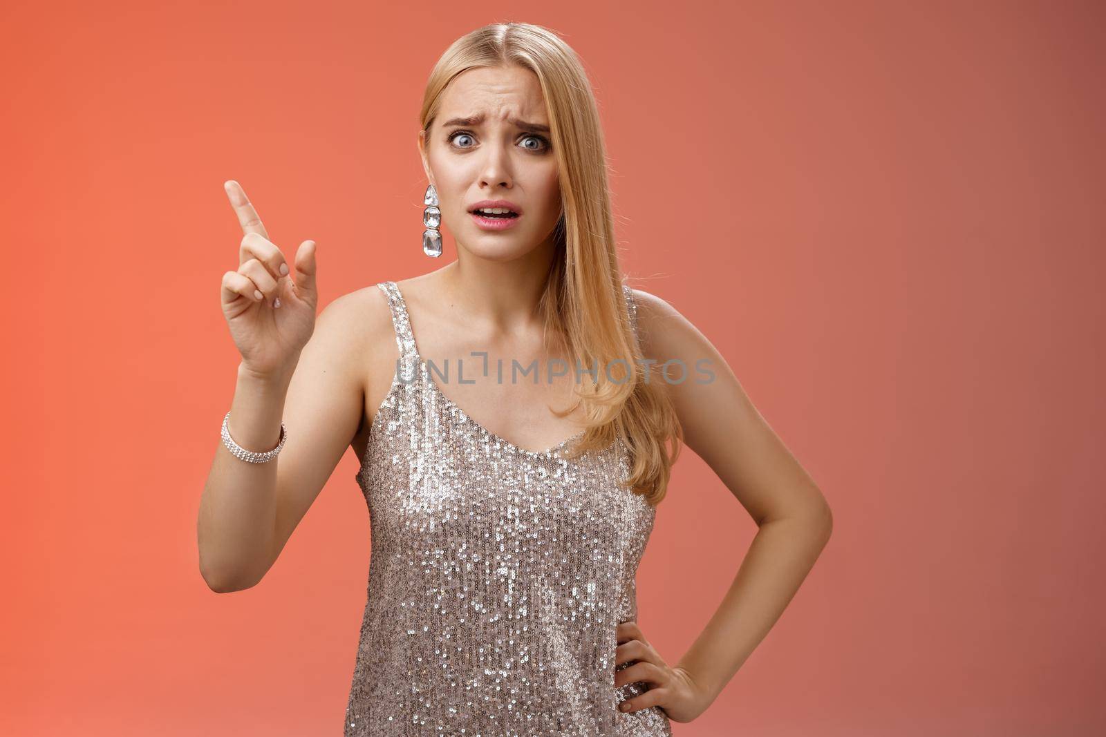 How could you. Disappointed let down upset complaining young woman demanding respect raise index finger scolding teaching lesson give instructions standing bothered displeased, red background by Benzoix
