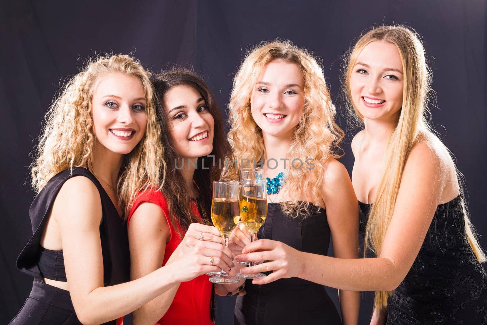 Party, holidays, celebration and new year eve concept - Cheerful young woman clinking glasses of champagne at the party by Satura86