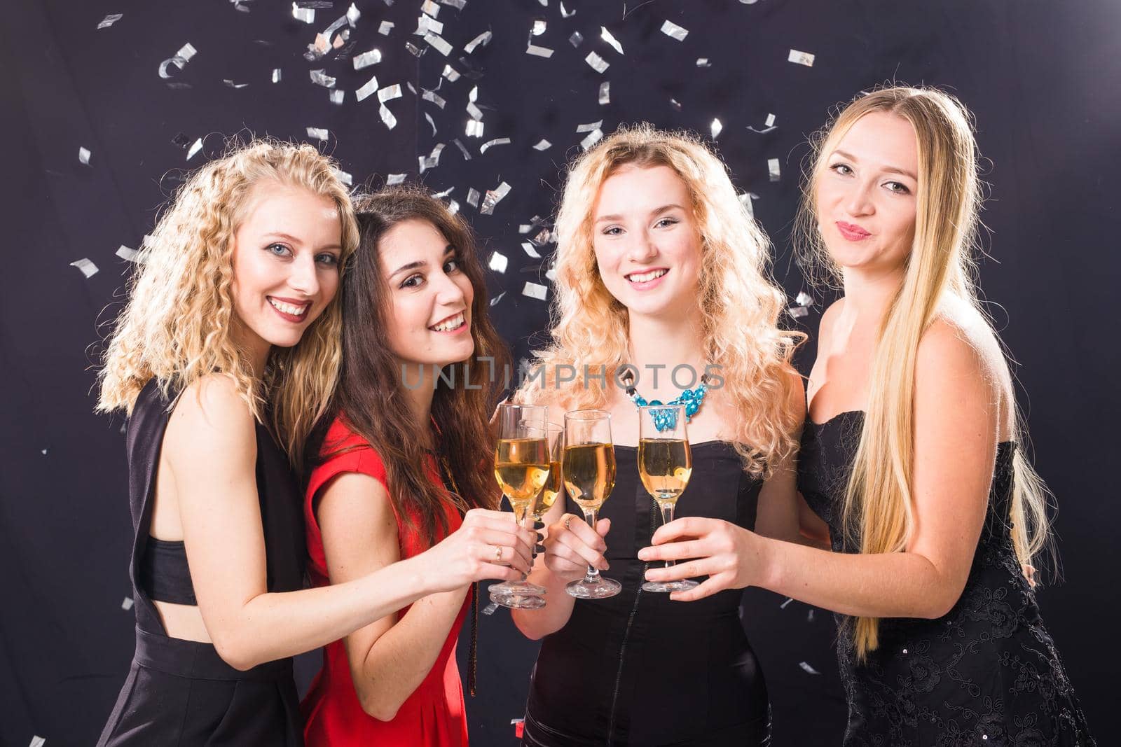 Party, new year and people concept - Cheerful young women clinking glasses of champagne at the party by Satura86