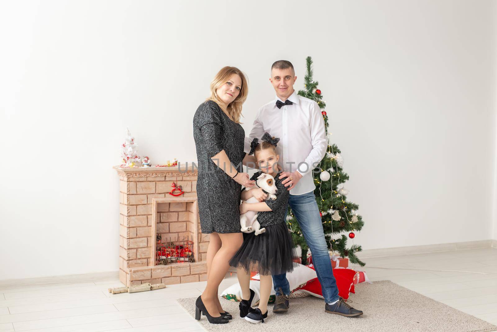 Holidays concept - happy family mother father and child at christmas tree at home by Satura86