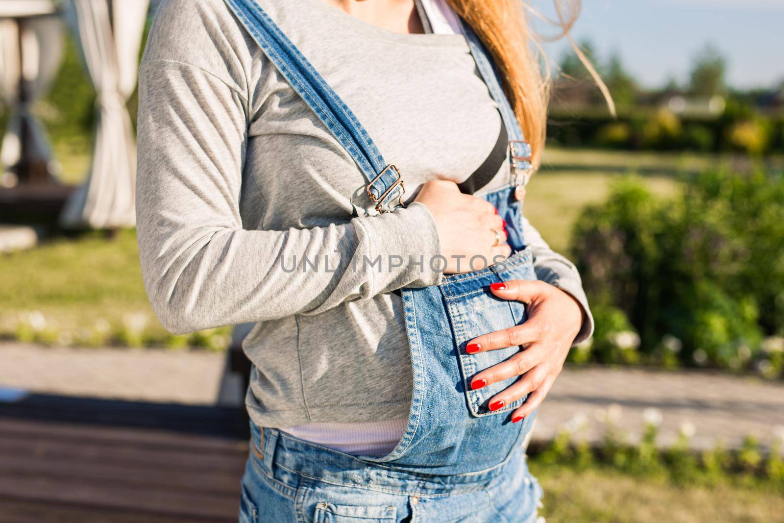 Close up of a cute pregnant belly outdoors