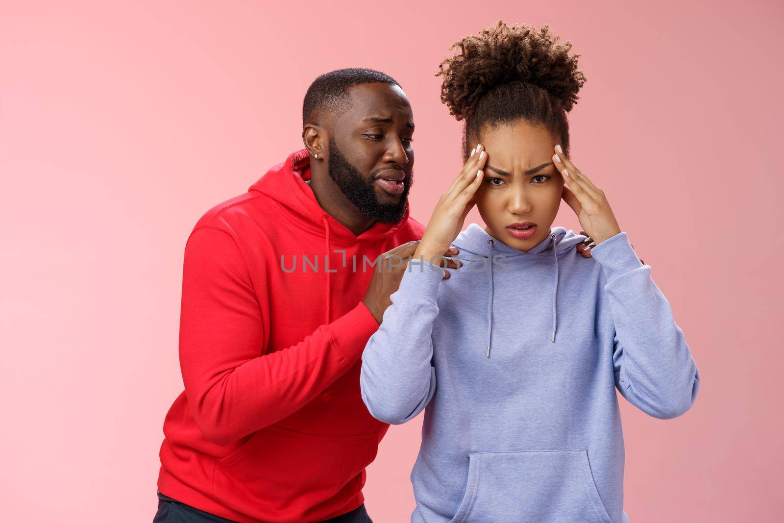 African american couple have fight arguing woman fed up cannot hear apologize anymore hold hands temples frowning pressured annoyed man begging forgiveness behind back supplicating say sorry.