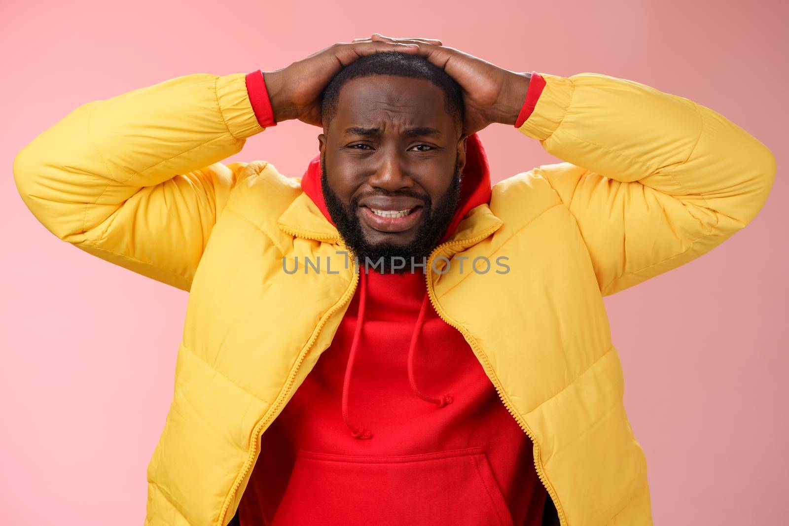 Upset unhappy african-american male entrepreneur lose money feel regret sadness grimacing painful heartbreaking feelings, holding hands head depressed devastated, standing pink background by Benzoix