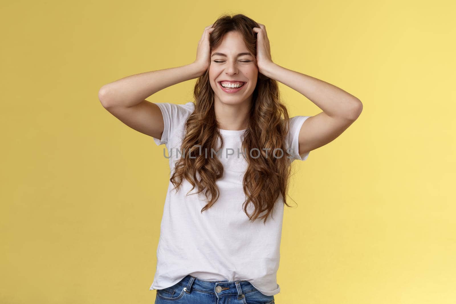 Joyful happy enthusiastic good-looking girl receive unbelievable awesome opportunity travel summer vacation abroad grab head close eyes smiling happily triumphing upbeat yellow background by Benzoix