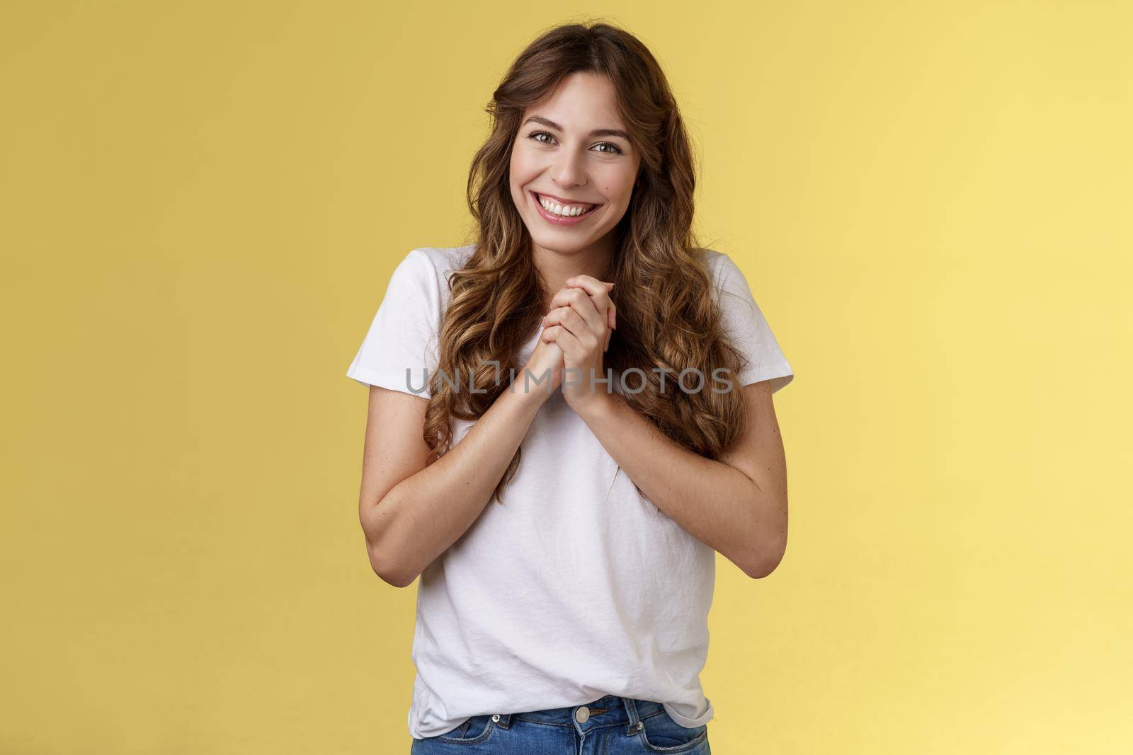 Cute lovely silly attractive female coworker appreciate friends farewell party office clasp hands thanking everyone awesome event smiling broadly delighted love adore you stand yellow background by Benzoix
