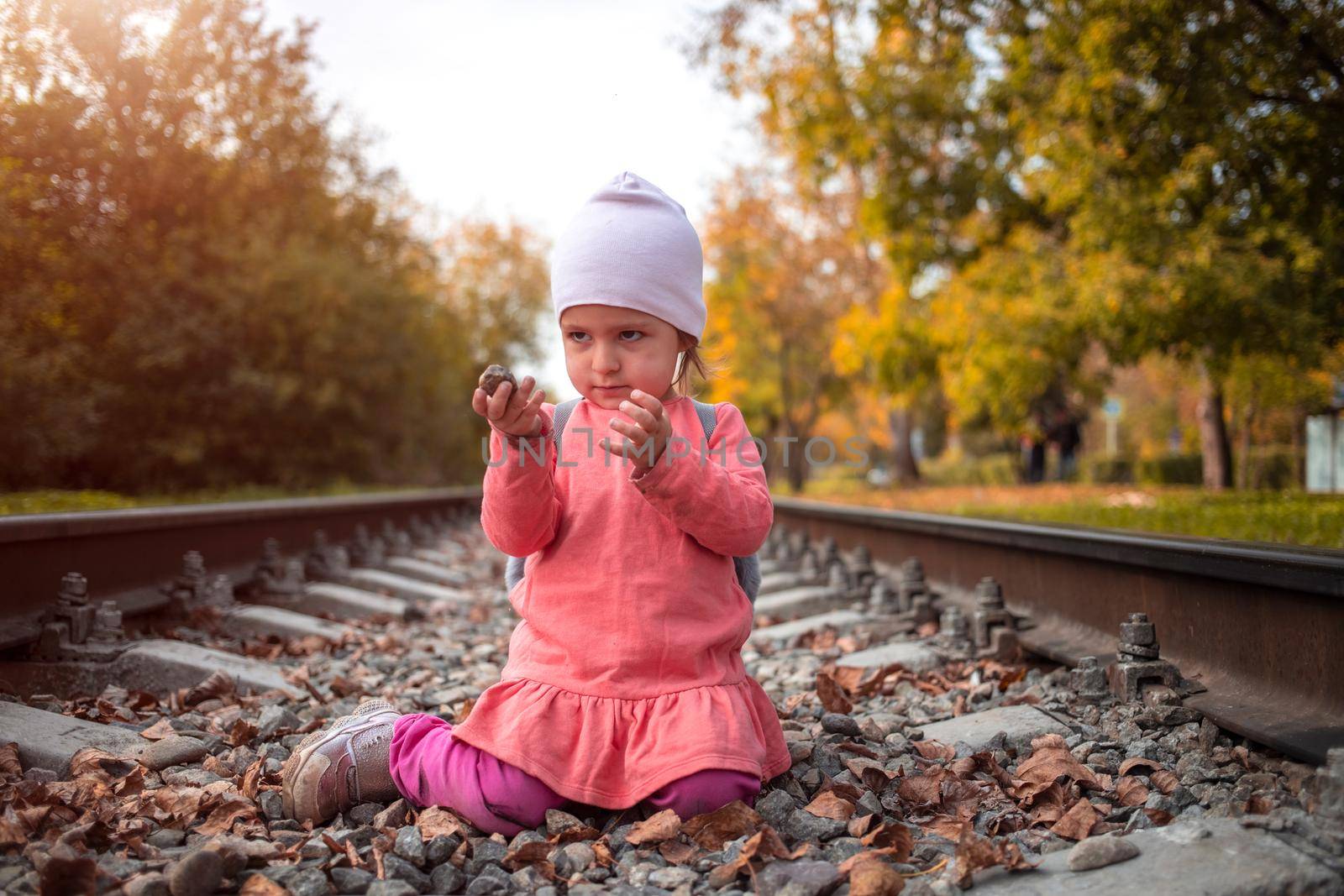 toddler girl on railroad alone autumn day by Mariaprovector