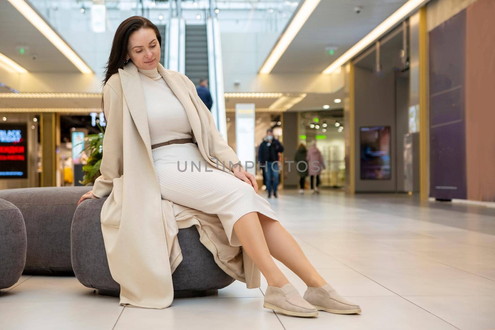 beautiful woman sitting on bench in the mall