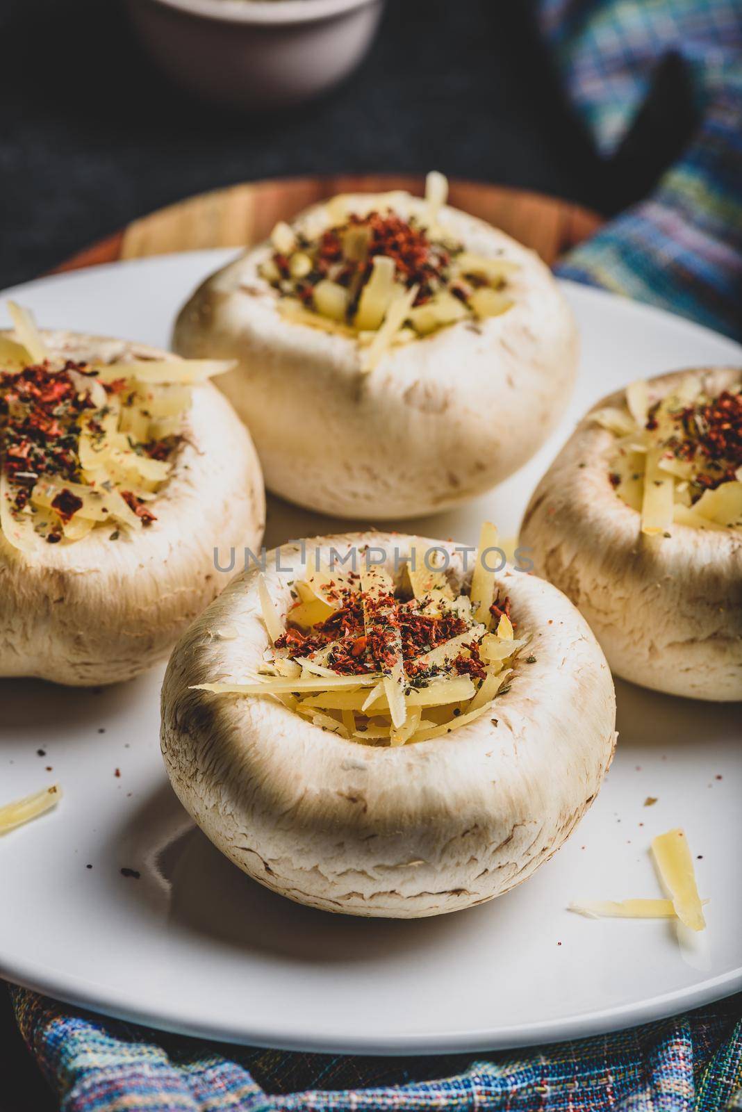 Button mushrooms stuffed with grated cheddar cheese and spices