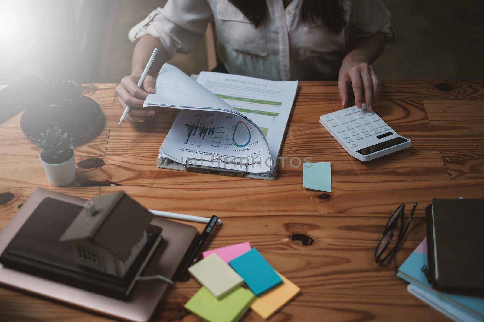 A businesswoman examines a financial chart in order to make arrangements. Investment concept for a business fund