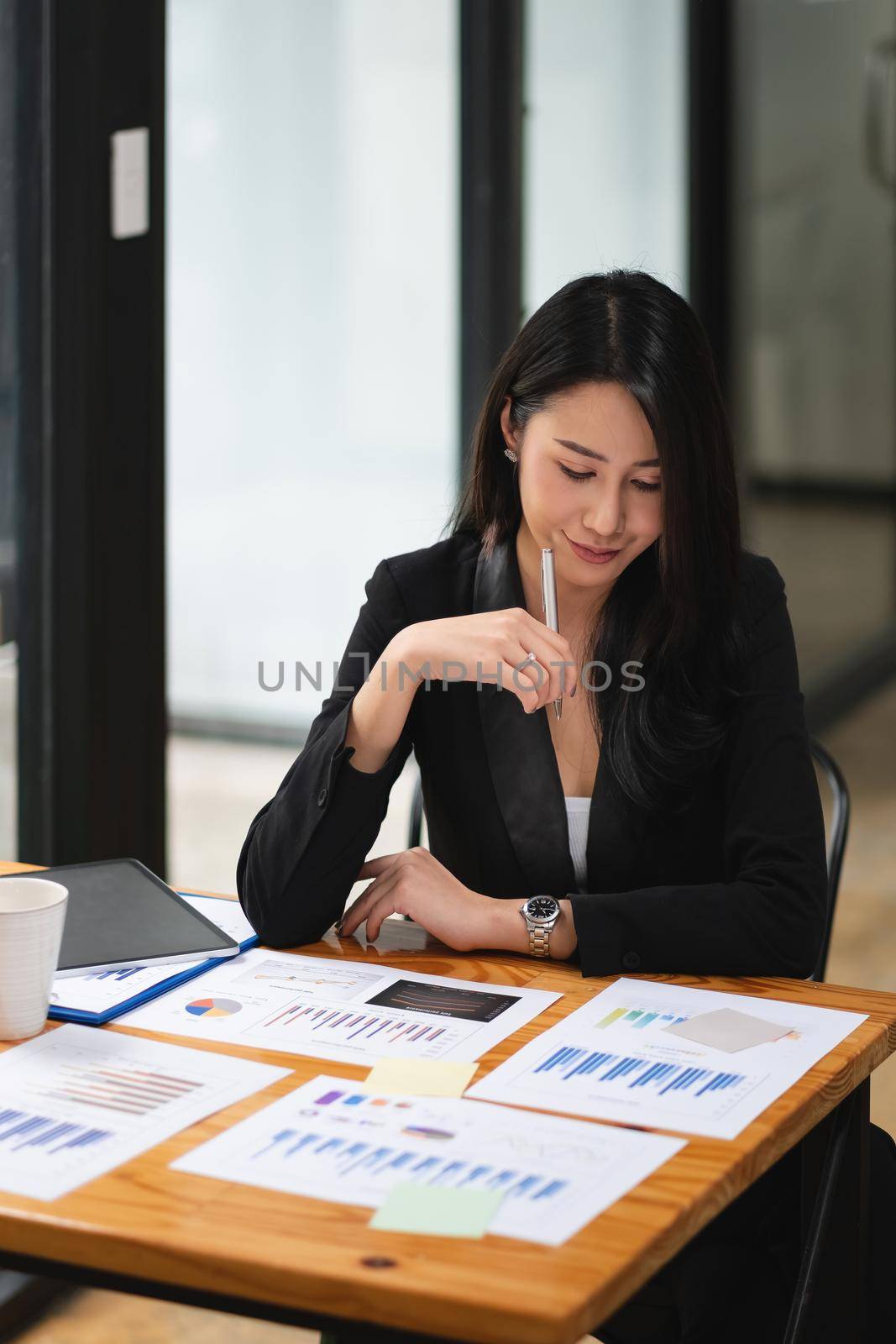 Portrait Of Attractive Asian Businesswoman Working for marketing plan.