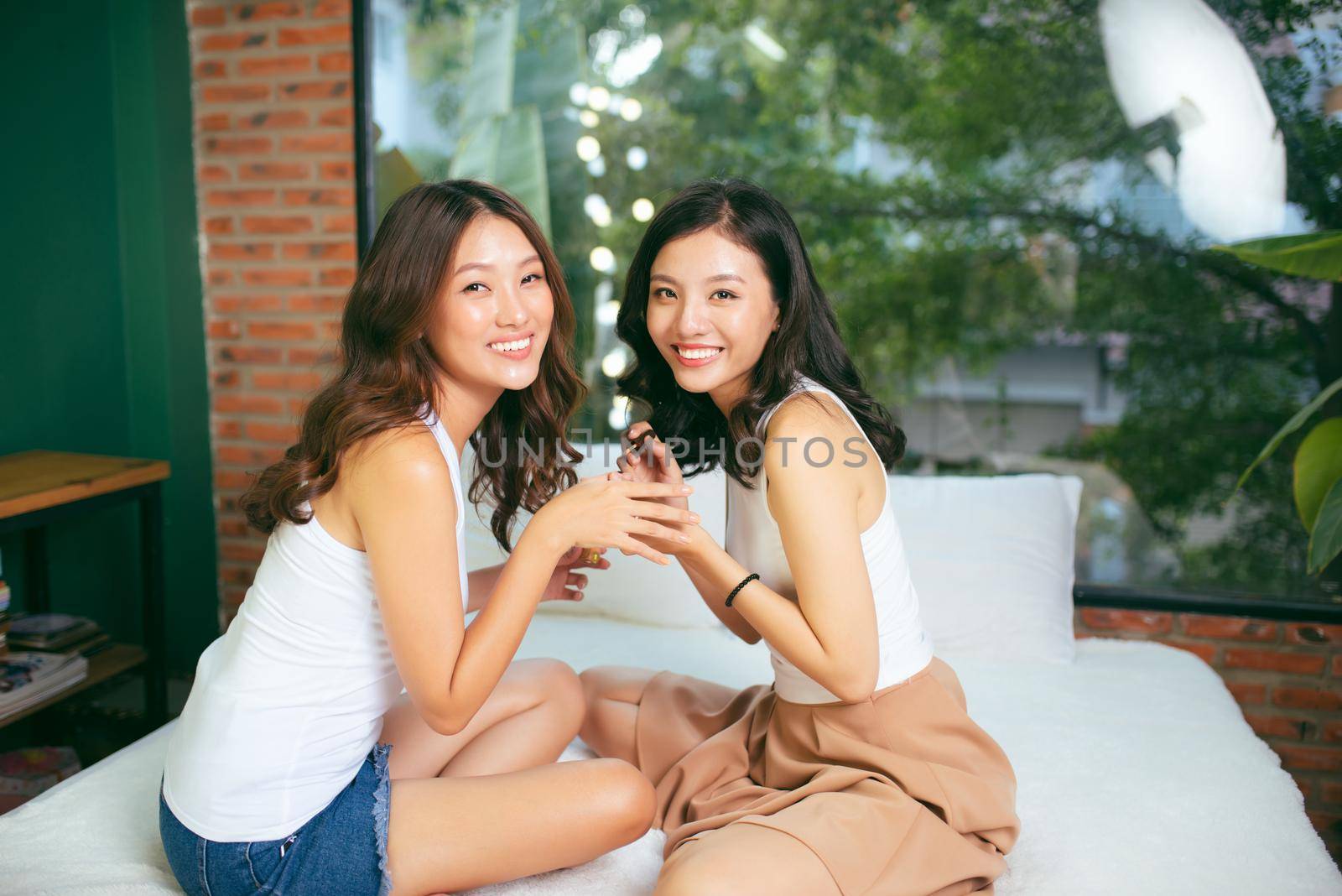 Two female friends do a manicure. The concept of hand care.