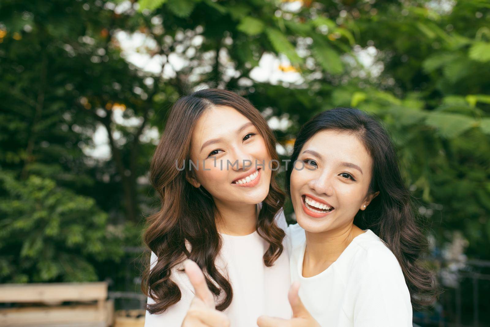 young pretty girlfriends over nature background, in the garden