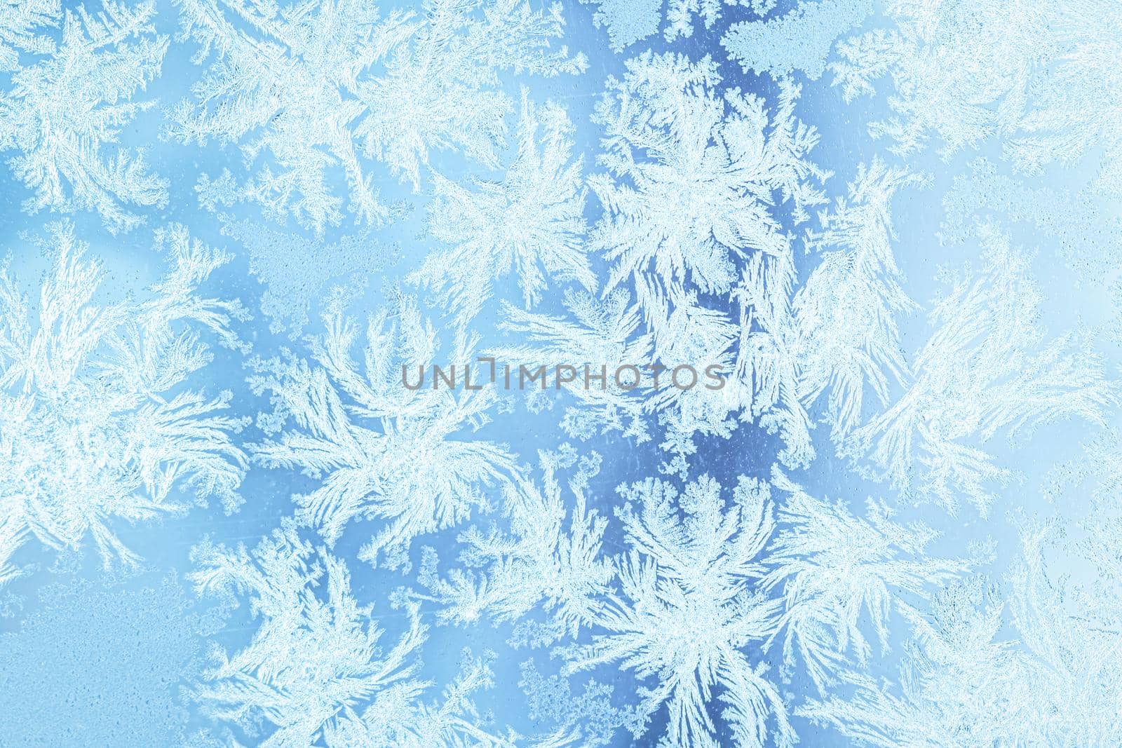 The texture of the glass covered with frost in winter in cold weather. Abstract natural background.