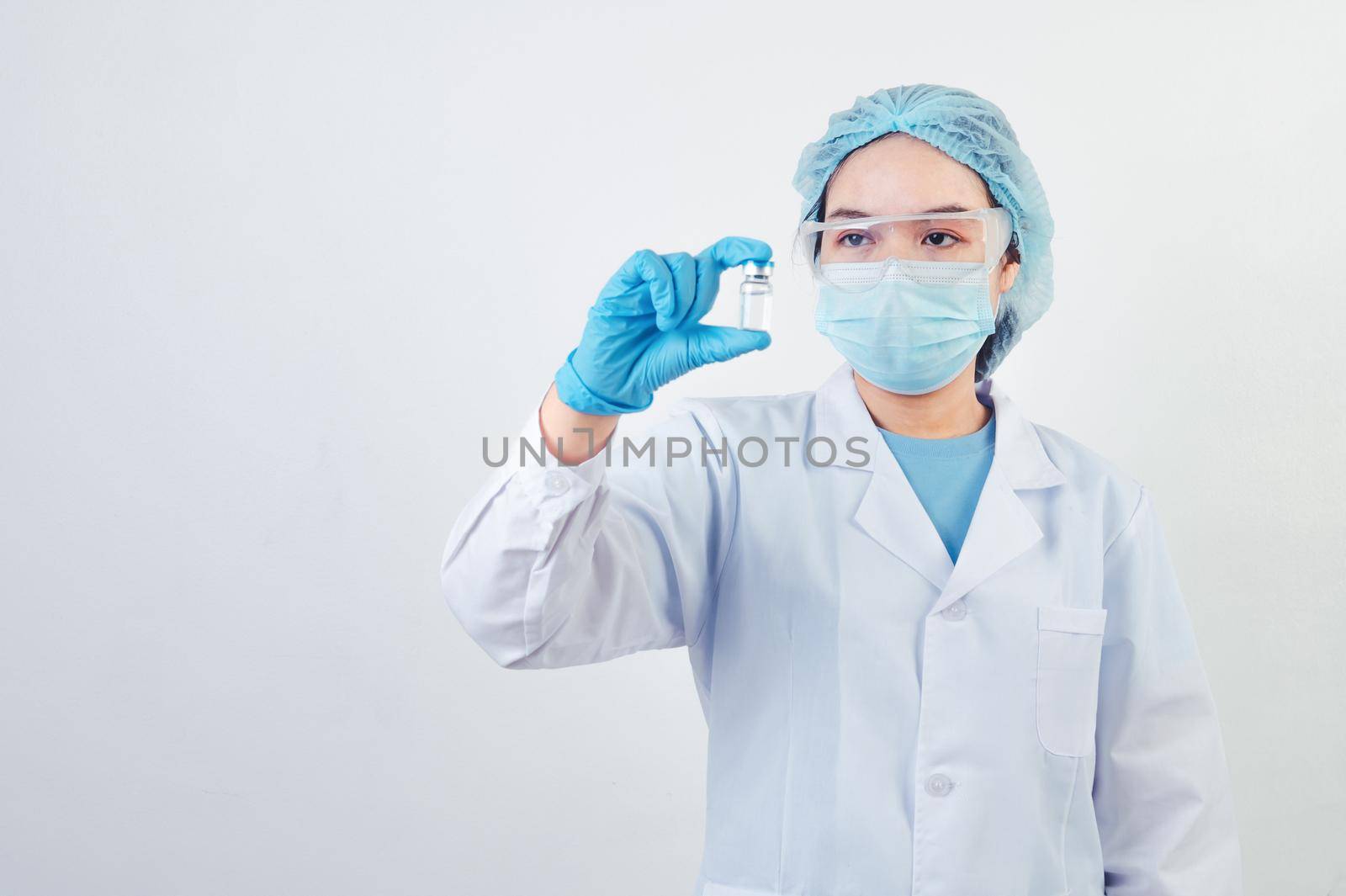 Professional scientist or doctor holding Covid-19 vaccine vial in hand of at laboratory for treatment with mask gloves and lab coat on white background. Health business and industry concept.