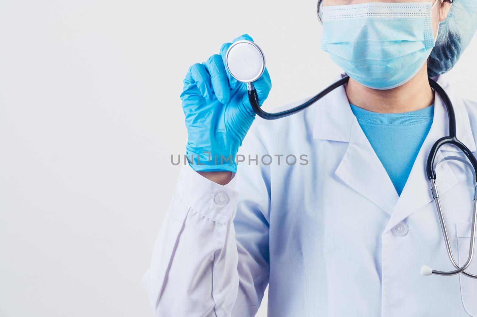 Closeup stethoscope in doctor hands with copy space on white background. Medical people and hospital annual health check concept. Psychologist and general practitioner by MiniStocker