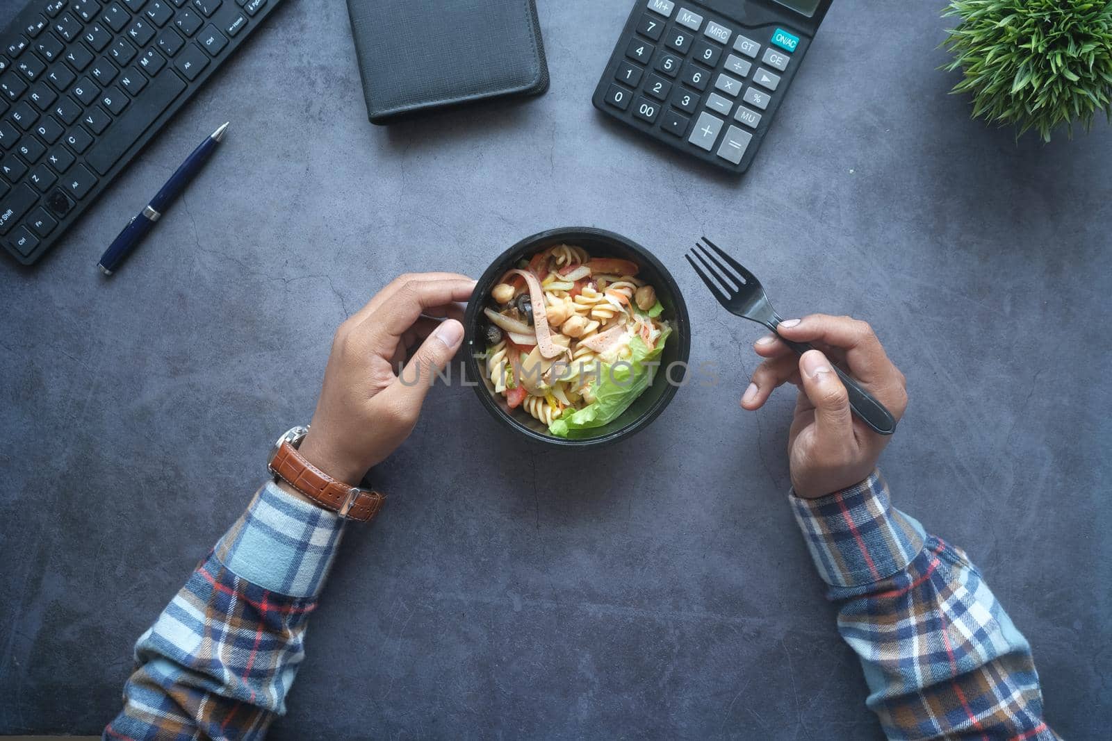 top view of bowl of fresh boiled vegetables on office desk.