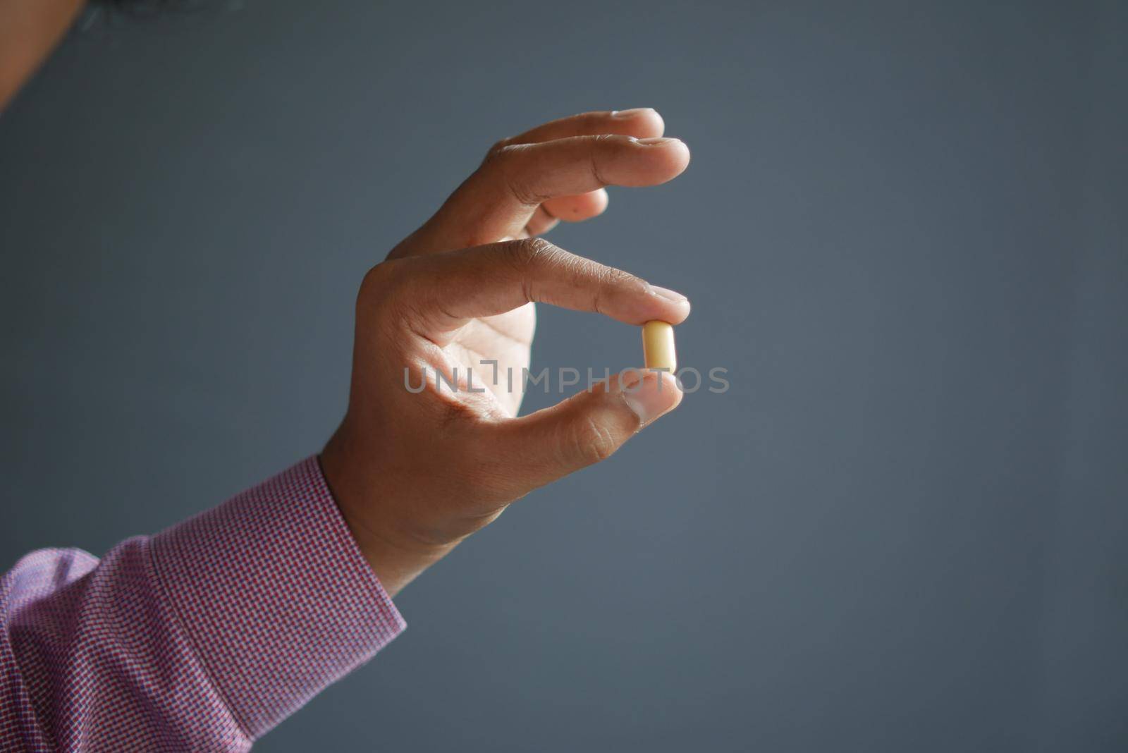 Close up of man hand holding pills with copy space .