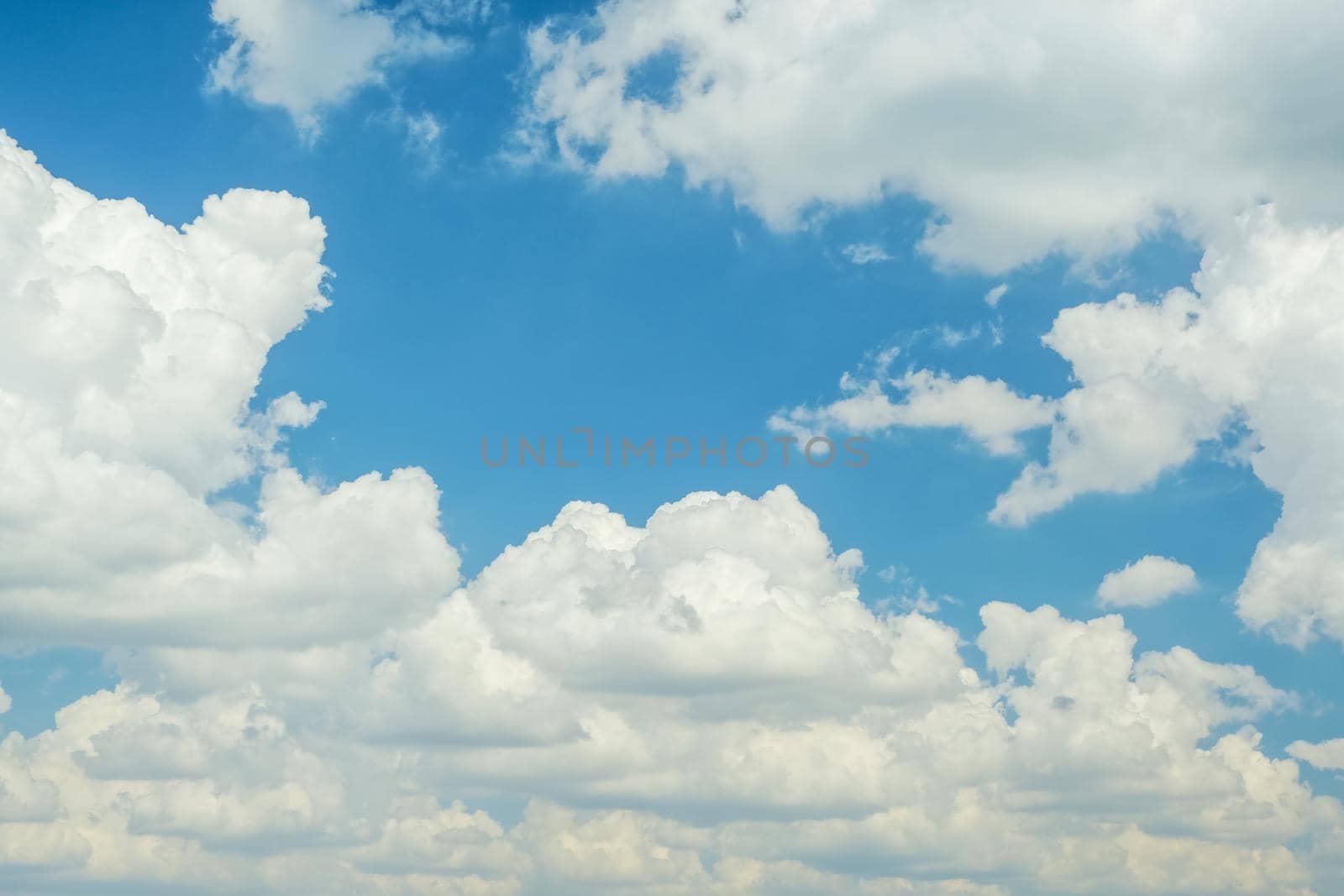 Blue sky with fluffy clouds during day time in summer.