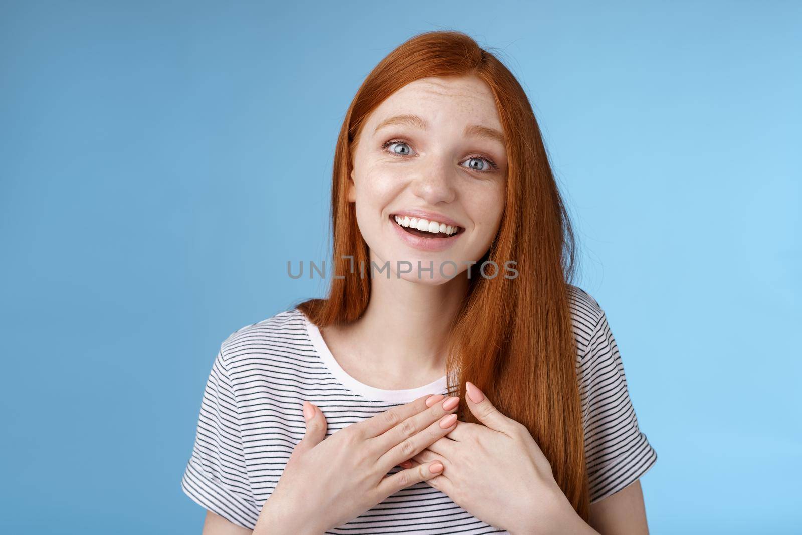 Kind fascinated touched romantic passionate redhead girl blue eyes sighing admiration delight touch heart palms smiling happily grinning grateful thanking friend express gratitude, studio background by Benzoix