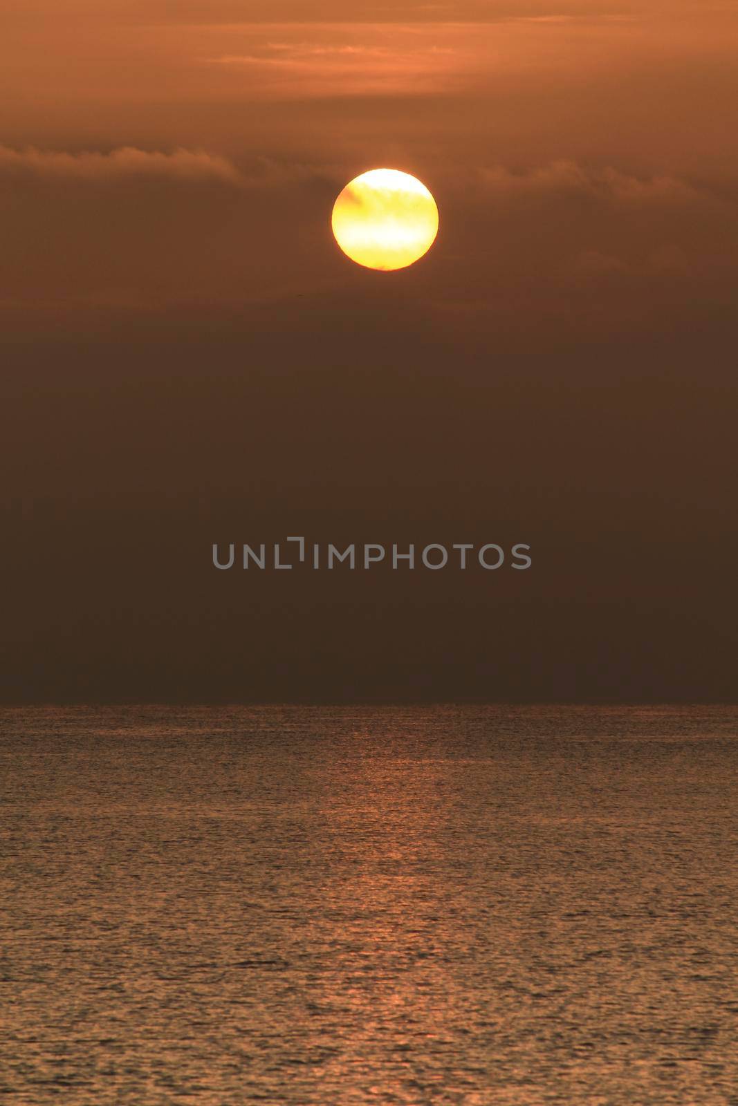 Colorful sun at sunrise over the mediterranean sea in southern Spain in Winter